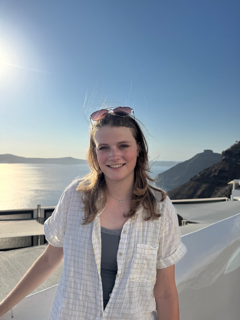 Cailin smiling on a terrace above the sea