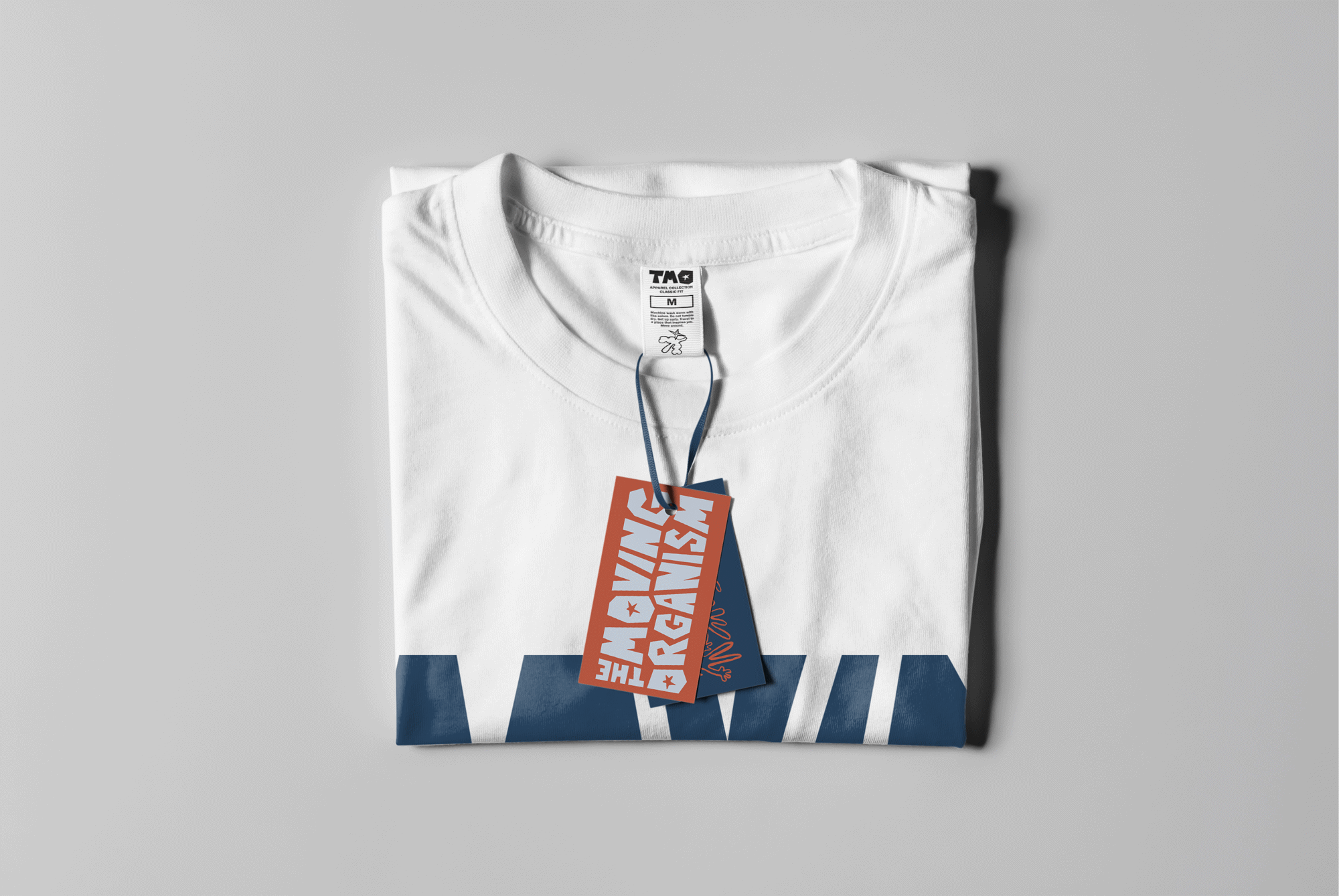 Folded T-shirt with an orange hang tag and a neck label carrying the wordmark